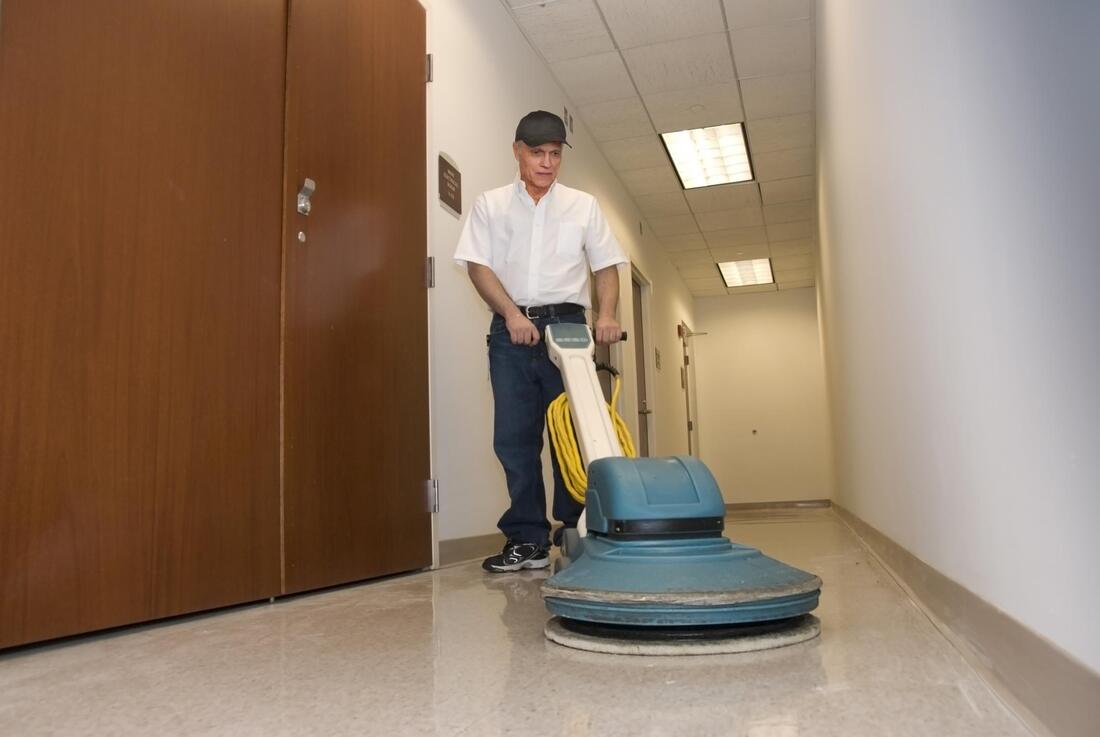 a man cleaning the office floor